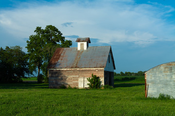 Old barn and grass field