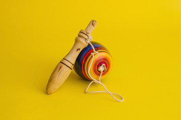 balero mexican toys from Wooden, balero, yoyo and trompo in Mexico on a yellow background