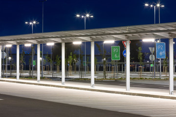 covered corridor for pedestrian in a modern parking lot at night with bright illumination