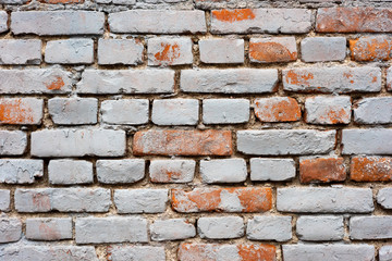 Old brick wall with red spots