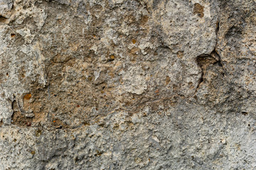 Texture of a concrete wall with cracks and scratches which can be used as a background