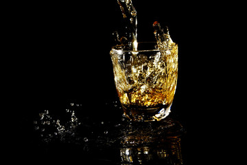 Pouring beverage on transparent glass