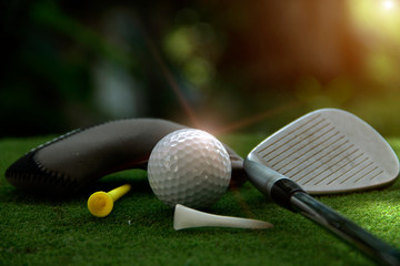 Golf ball and golf club in beautiful golf course at Thailand. Collection of golf equipment resting...