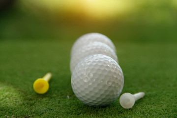 Golf ball and golf club in beautiful golf course at Thailand. Collection of golf equipment resting on green grass with green background