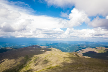 Amazing view on green mountains from a viewpoint. Panorama of the mountains  in Altai on a summer clear day. A landscape view of beautiful fresh green field   and  Altai mountain background.