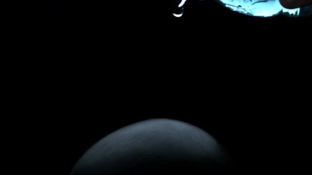 vfx plate shot of water spill drops on black sphere head and background v08
