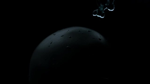 vfx plate shot of water spill drops on black sphere head and background v09