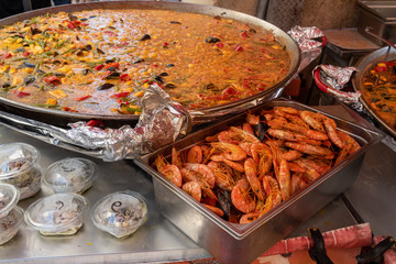 Street food, large pan of paella seafood cooking on market in Provence, France