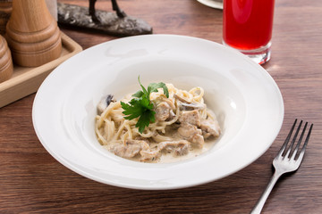 Mushroom chicken Spaghetti with cream sauce and berry drink on wooden table