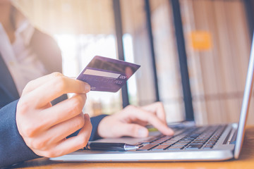 Business woman hand holds a blue credit card.