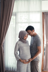 pregnancy muslim woman. happy asian romantic couple expecting baby