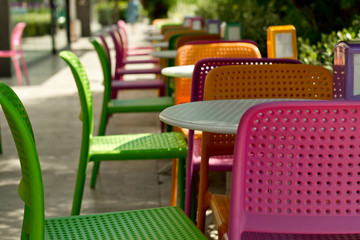 Plastic colorful tables and chairs in the cafe.