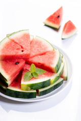 Slices of fresh watermelon on white marble background