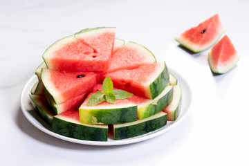 Slices of fresh watermelon on white marble background