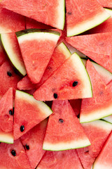 Slices of fresh watermelon covering as background