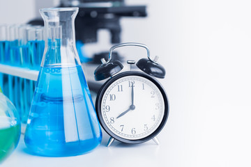 Time clock with Chemical Glassware for Medical Science Research in Laboratory
