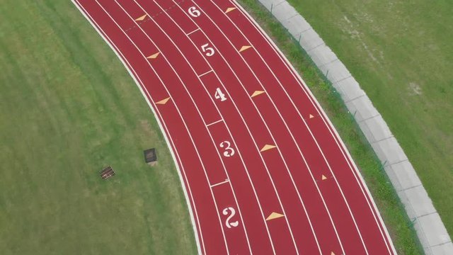 Aerial view of high school track field with the lane numbers for starting long-distance running events