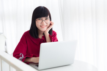 Asian nerdy teen happy smile with laptop computer working women