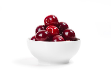 Cherries in cup isolated on white background.
