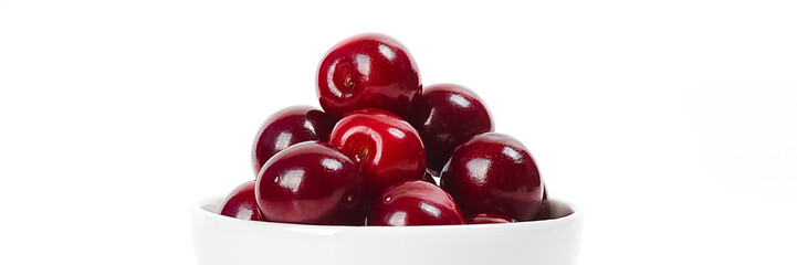 Cherries in cup isolated on white background.