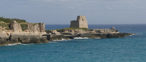 Fototapeta na wymiar Castle ruins and lookout Tower overlooking the Adriatic sea in Roca in Salento. Roca is an important archaeological excavations site and a touristic center in Salento.