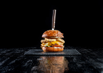 Homemade double cheese burger with onion ring.