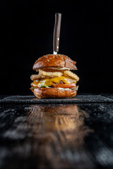 Homemade double cheese burger with onion ring.