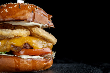 Homemade double cheese burger with onion ring.