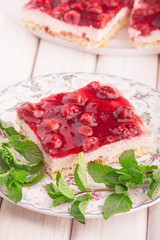 Home made cherry cake with mint on white wooden table