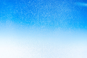 close up ice with frost on windows of airplane and blue sky