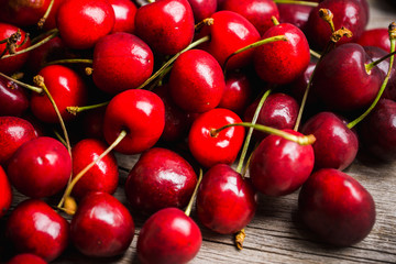 Ripe and juicy cherries on the dark rustic background. Selective focus. Shallow depth of field.