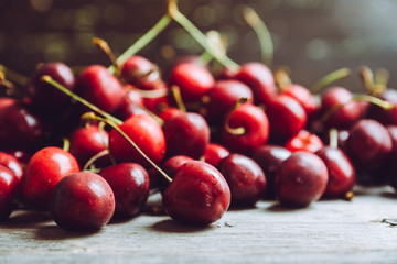 Ripe and juicy cherries on the dark rustic background. Selective focus. Shallow depth of field.