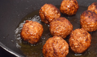 Meatballs in cooking pan by frying