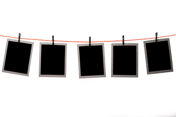 Blank Polaroid pictures hanging in a line on white background - Powered by Adobe