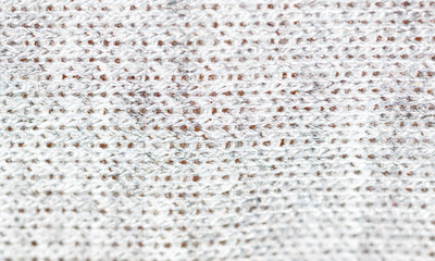 Knitted light surface of wool things as a background.