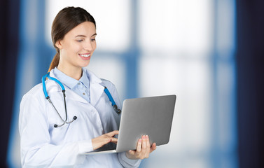 Portrait of an attractive young female doctor in white coat