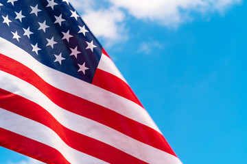 American flag waving in the wind against blue sky