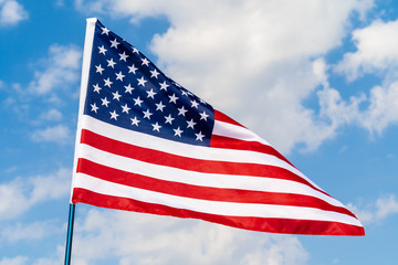 American flag waving in the wind against blue sky