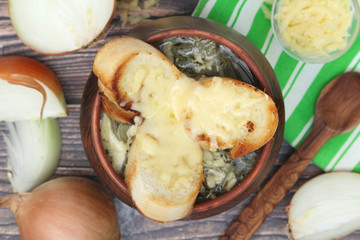 A ceramic pot with French onion soup