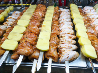 Meat with potatoes on skewers for frying on the grill