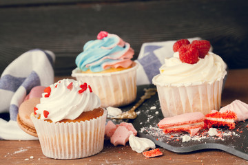 Tasty cupcakes on a dark wooden table