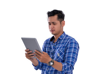 portrait of asian young man looking at digital tablet with isolated background