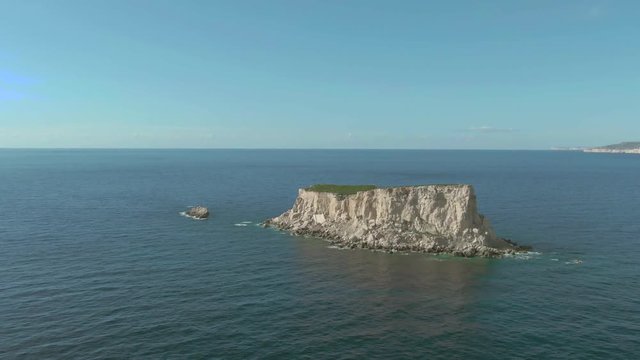 Aerial flight towards Filfla island with Malta in the background in the Maltese archipelago