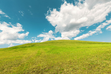 Idyllic minimalistic relaxing landscape with grassy hill and colorful sky