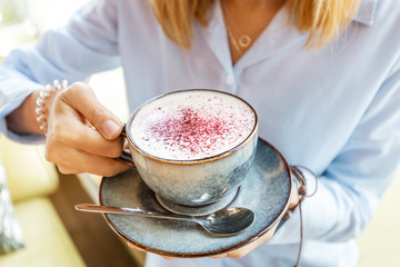Huge cup of cappuccino with foam in a cafe