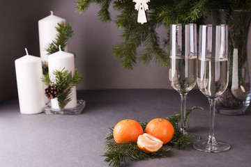 two champagne glasses, Merry Christmas fir branchs, candles, card for new year greeting