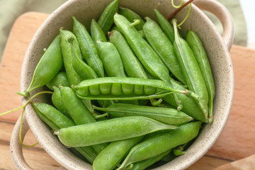 Pot with tasty fresh peas on table, closeup