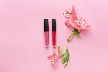 Set of lipglosses on color background