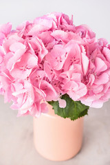 Vase with beautiful hydrangea flowers on table