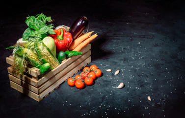 Healthy food background. Concept of healthy food, fresh vegetables in box on a dark background